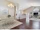 Open-concept living area featuring hardwood floors, vaulted ceilings, and a decorative chandelier at 6716 Frontier Ln, Tampa, FL 33625