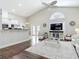 Open-concept living room with vaulted ceiling, breakfast bar, and dark hardwood floors at 6716 Frontier Ln, Tampa, FL 33625