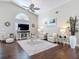 Bright living room with vaulted ceilings, ceiling fan, and neutral color palette at 6716 Frontier Ln, Tampa, FL 33625