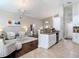 Bright open-concept living room with stylish furniture, modern ceiling fan, and beautiful hardwood floors at 6716 Frontier Ln, Tampa, FL 33625