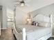 Luxurious primary bedroom with a large bed, white furniture, and wood floors, offering a serene retreat at 6716 Frontier Ln, Tampa, FL 33625