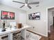 Spacious office featuring a large white desk, stylish artwork, and modern decor elements at 6716 Frontier Ln, Tampa, FL 33625