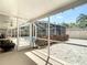Enclosed patio with stone flooring that offers outdoor space and view of screened-in pool at 6716 Frontier Ln, Tampa, FL 33625