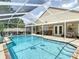 Beautiful pool area with a screened enclosure, lounge seating and an outdoor kitchen perfect for entertaining at 6716 Frontier Ln, Tampa, FL 33625
