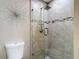 Modern shower with glass door and tile, featuring updated fixtures and design for a comfortable bathing experience at 6716 Frontier Ln, Tampa, FL 33625