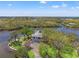 Stunning aerial view of the unique property surrounded by water, showcasing its private and picturesque location at 7049 Peninsular Dr, New Port Richey, FL 34652