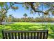 Relax on the backyard bench swing amidst waterfront views, lush greenery, and serene outdoor living spaces at 7049 Peninsular Dr, New Port Richey, FL 34652