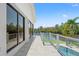 Enjoy this home's stunning waterfront balcony view with glass railings, perfect for outdoor relaxation and entertaining at 7049 Peninsular Dr, New Port Richey, FL 34652