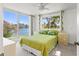 Light-filled bedroom featuring water views, complementing the bed dressed in green linens at 7049 Peninsular Dr, New Port Richey, FL 34652