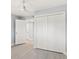 Light and airy bedroom featuring modern gray flooring and closet with white panel doors at 7049 Peninsular Dr, New Port Richey, FL 34652
