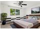 A bright bedroom with a view, featuring decor and a ceiling fan for optimal comfort at 7049 Peninsular Dr, New Port Richey, FL 34652
