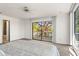 Bedroom with neutral carpet, ceiling fan, access to an ensuite bathroom and a balcony with peaceful views at 7049 Peninsular Dr, New Port Richey, FL 34652