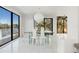 Bright dining room with water views, a glass table, and modern decor at 7049 Peninsular Dr, New Port Richey, FL 34652
