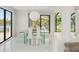 Bright dining room featuring views of the water and a contemporary glass table set for elegant dining at 7049 Peninsular Dr, New Port Richey, FL 34652
