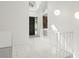 Inviting entryway with tile floors, a modern staircase, and an eye-catching stone accent wall at 7049 Peninsular Dr, New Port Richey, FL 34652