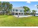 Expansive backyard with lush grass and an inviting pool overlooking the scenic canal at 7049 Peninsular Dr, New Port Richey, FL 34652