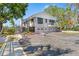 Beautiful home features multiple balconies, three-car garage, and lush landscaping, providing a luxurious living experience at 7049 Peninsular Dr, New Port Richey, FL 34652