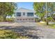 Charming home featuring a three car garage, lush landscaping, and a well-maintained driveway at 7049 Peninsular Dr, New Port Richey, FL 34652