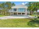 Stunning waterfront home featuring a beautiful backyard pool and spacious outdoor area for entertaining and relaxation at 7049 Peninsular Dr, New Port Richey, FL 34652