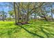 Spacious lawn showcases this stunning waterfront home with mature shade trees for a relaxing and private outdoor lifestyle at 7049 Peninsular Dr, New Port Richey, FL 34652