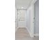 Hallway with wood-look floors and doors leading to the outdoors at 7049 Peninsular Dr, New Port Richey, FL 34652