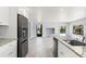 Modern kitchen with island, stainless steel appliances and an open floorplan at 7049 Peninsular Dr, New Port Richey, FL 34652