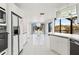 A bright, open white kitchen featuring modern appliances and an island overlooking the water view at 7049 Peninsular Dr, New Port Richey, FL 34652