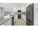 Modern kitchen with white cabinets, stainless steel appliances, and granite countertops at 7049 Peninsular Dr, New Port Richey, FL 34652