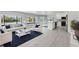 Open-concept living area features modern finishes, a water view, comfortable seating, and an adjacent updated kitchen at 7049 Peninsular Dr, New Port Richey, FL 34652