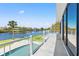 Relax on the covered patio with views of the pool, waterfront, and lush landscaping at 7049 Peninsular Dr, New Port Richey, FL 34652