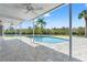 Beautiful in-ground pool featuring a picturesque canal view and large tile patio at 7049 Peninsular Dr, New Port Richey, FL 34652