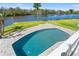 Inviting pool with brick pavers overlooks the water, offering a serene spot to relax and unwind in your own backyard at 7049 Peninsular Dr, New Port Richey, FL 34652