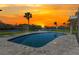 Enjoy sunset views from the private pool with lovely pool deck and tropical landscaping at 7049 Peninsular Dr, New Port Richey, FL 34652