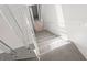 Carpeted stairway featuring transparent acrylic railing, creating an open and modern feel at 7049 Peninsular Dr, New Port Richey, FL 34652