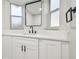 Bathroom with modern vanity featuring black hardware and marble countertop, with transom windows at 7804 N Whittier St, Tampa, FL 33617