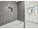 Updated bathroom with gray tiled shower, modern fixtures, and stylish vanity at 7804 N Whittier St, Tampa, FL 33617