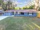 Charming single-story home featuring a well-manicured lawn, mature trees and a freshly painted exterior at 7804 N Whittier St, Tampa, FL 33617