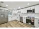 Bright kitchen with stainless steel appliances, white cabinetry, and stylish countertops at 7804 N Whittier St, Tampa, FL 33617