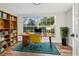 Inviting home office space with a large window, built-in shelving, and hardwood floors, creating a productive workspace at 7804 N Whittier St, Tampa, FL 33617