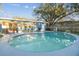 Inviting backyard pool with patio furniture, mature trees, and privacy fence at 7804 N Whittier St, Tampa, FL 33617
