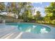 Backyard in-ground pool with well-maintained deck is perfect for relaxing and enjoying the outdoors at 7804 N Whittier St, Tampa, FL 33617