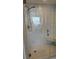 Modern shower with stylish tile, glass door, and built-in bench at 7984 Sailboat Key S Blvd # 105, South Pasadena, FL 33707