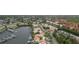 Aerial view of the waterfront community featuring boat docks, tennis courts, and residential homes at 8707 Sailmaker Ct, Tampa, FL 33615