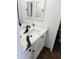 Bright bathroom featuring a white vanity with dark hardware, modern mirror, and tile flooring at 8707 Sailmaker Ct, Tampa, FL 33615