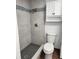Stylish bathroom featuring a shower with tiled surround and mosaic accents, paired with a modern toilet at 8707 Sailmaker Ct, Tampa, FL 33615