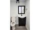 Bathroom featuring new floors, vanity, mirror and lighting, and toilet at 8707 Sailmaker Ct, Tampa, FL 33615