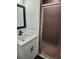 Bathroom with a vanity and frosted glass shower doors at 8707 Sailmaker Ct, Tampa, FL 33615
