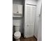 Bathroom with white cabinet storage, toilet, and tile flooring at 8707 Sailmaker Ct, Tampa, FL 33615