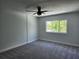 Comfortable bedroom filled with natural light and complete with a fan at 8707 Sailmaker Ct, Tampa, FL 33615
