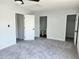 Spacious bedroom featuring three doors leading to closet and bath at 8707 Sailmaker Ct, Tampa, FL 33615